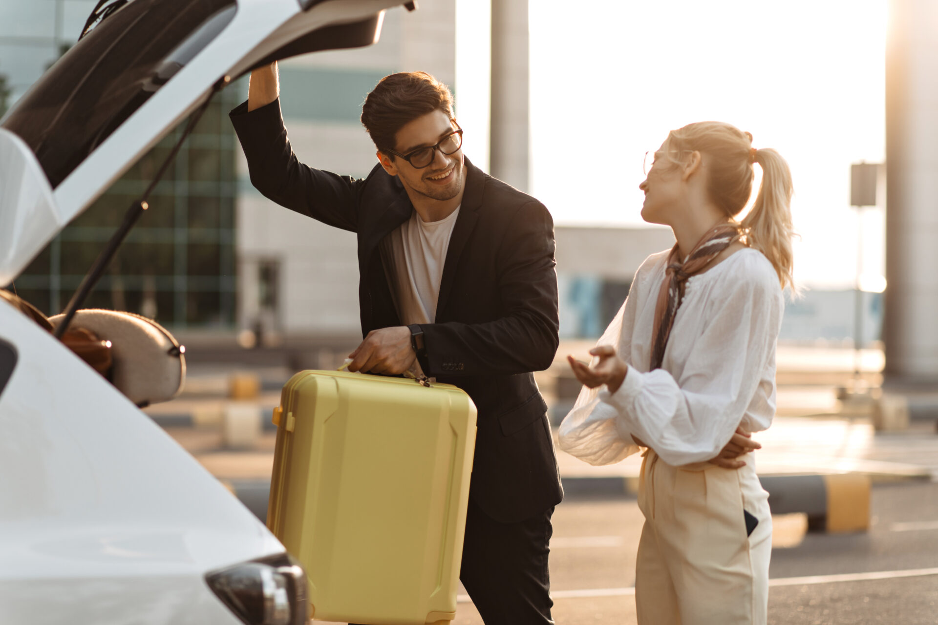 A man and a woman standing next to a car at Corfu Airport